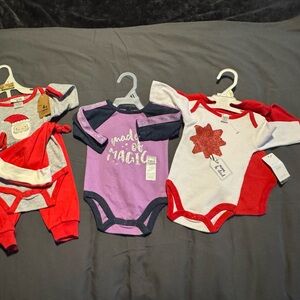 4) size 0-3 months outfits. 3) onesies, 1) onesie with pants and Santa hat!
